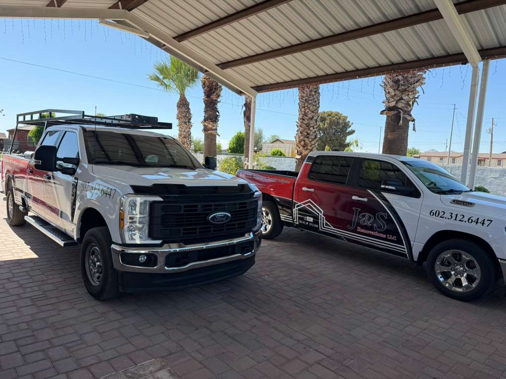 J&S Renovations roofing division truck with ladder rack and license info